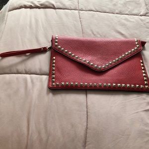 Gold studded red clutch with wristlet.